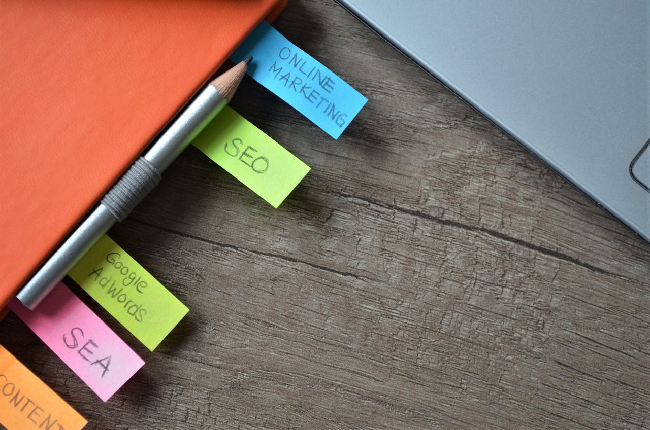 about-01 Close-up of SEO strategy planner with colorful sticky notes and a pencil on a notebook.